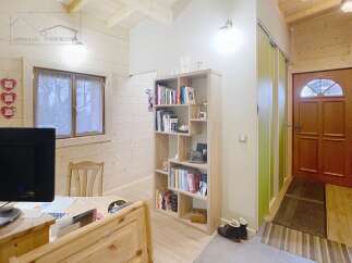 This charming property features a cozy interior with wooden accents, creating a warm and inviting atmosphere.