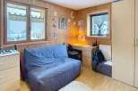 Discover this charming room featuring a cozy sofa, perfect for relaxation.
