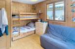 Discover the charm of this cozy bedroom featuring a wooden bunk bed, perfect for accommodating guests or family.