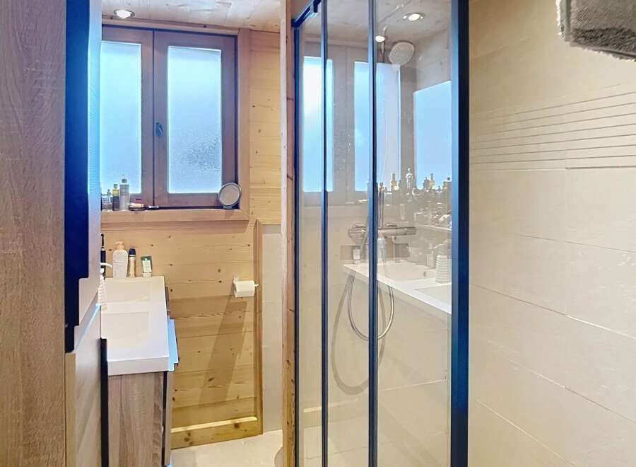 Step into this beautifully designed bathroom featuring a modern glass shower enclosure.