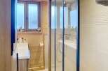 Step into this beautifully designed bathroom featuring a modern glass shower enclosure.