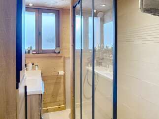Step into this beautifully designed bathroom featuring a modern glass shower enclosure.