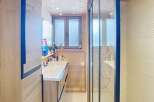 This stunning bathroom features a modern design with a sleek glass shower and a stylish vanity.