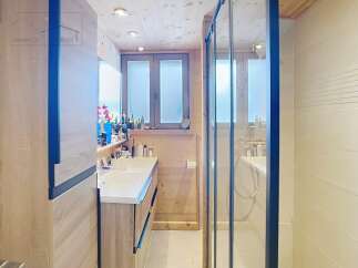 This stunning bathroom features a modern design with a sleek glass shower and a stylish vanity.