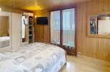 This cozy bedroom features a warm wooden interior, creating a welcoming atmosphere.