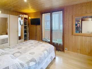 This cozy bedroom features a warm wooden interior, creating a welcoming atmosphere.