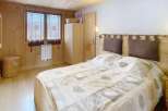 This cozy bedroom features a warm wooden interior, creating a rustic and inviting atmosphere.