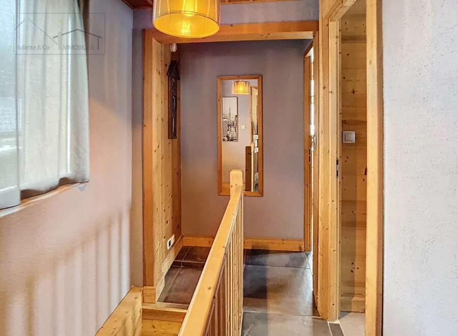 Step into this inviting hallway, featuring a warm wooden aesthetic that exudes rustic charm.