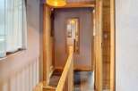 Step into this inviting hallway, featuring a warm wooden aesthetic that exudes rustic charm.