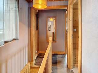 Step into this inviting hallway, featuring a warm wooden aesthetic that exudes rustic charm.