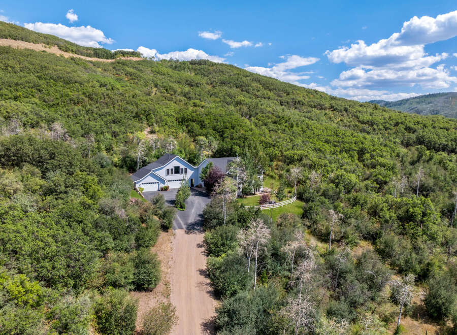 Nestled in a serene, wooded landscape, this stunning property offers unparalleled privacy and natural beauty.