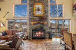 Experience the warmth and charm of this stunning living space, featuring a beautiful stone fireplace as the focal point.