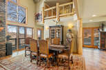 Step into luxury with this stunning dining room, featuring a grand wooden dining table and elegant chairs.