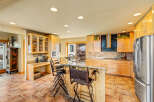 This stunning kitchen boasts a spacious layout with ample counter space and storage, perfect for culinary enthusiasts.