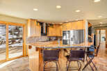 This stunning kitchen boasts a spacious layout with a beautiful granite countertop island, perfect for entertaining.