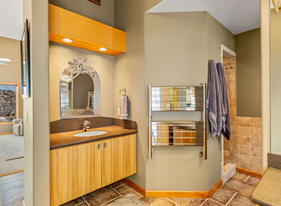 This stunning bathroom boasts a unique design with a stylish vanity and a decorative mirror.