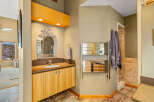 This stunning bathroom boasts a unique design with a stylish vanity and a decorative mirror.