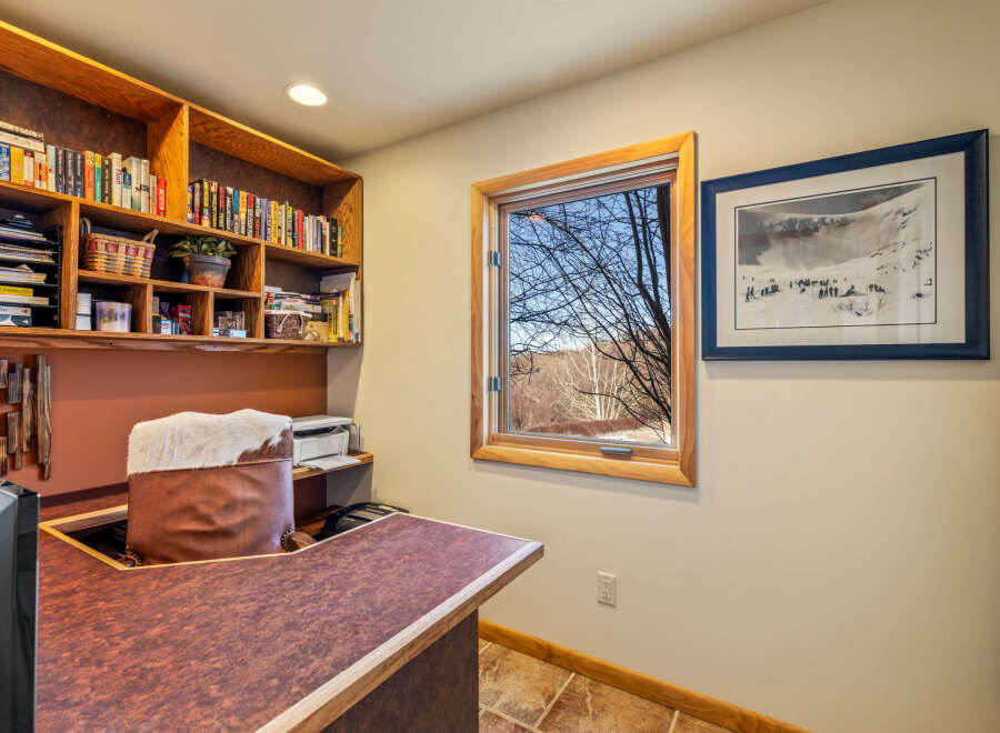 This inviting home office features a custom-built desk and shelving, perfect for productivity and organization.