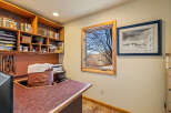 This inviting home office features a custom-built desk and shelving, perfect for productivity and organization.