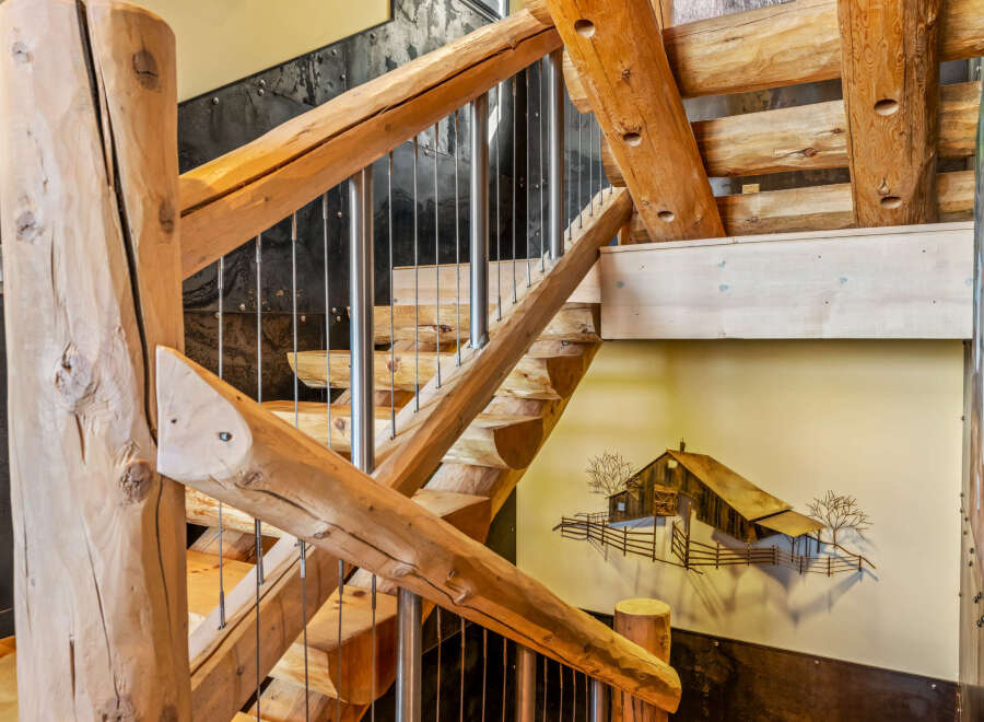 This stunning staircase showcases rustic elegance with its natural wood construction and unique design.
