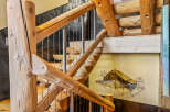 This stunning staircase showcases rustic elegance with its natural wood construction and unique design.