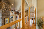 This stunning property boasts a grand entrance with a stone fireplace and a unique ceiling fan.