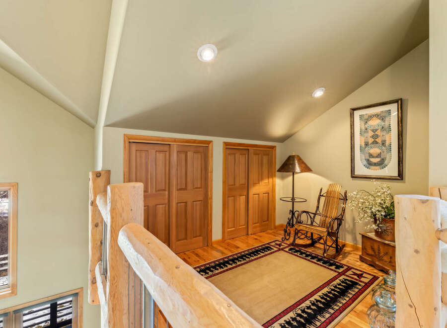 Step into this inviting space, featuring a cozy rocking chair and a stylish rug, perfect for relaxation.