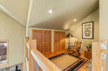 Step into this inviting space, featuring a cozy rocking chair and a stylish rug, perfect for relaxation.