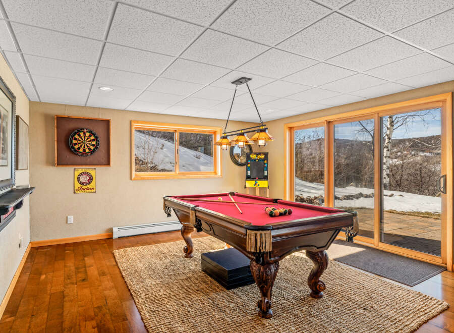 This stunning property features a game room with a pool table, perfect for entertaining guests.