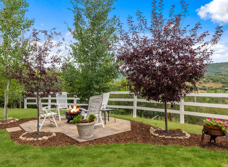 Enjoy outdoor living at its finest with this stunning property! Featuring a cozy patio with a fire pit, perfect for entertaining or relaxing.