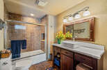 This beautiful bathroom features a modern vanity with a vessel sink and ample storage.