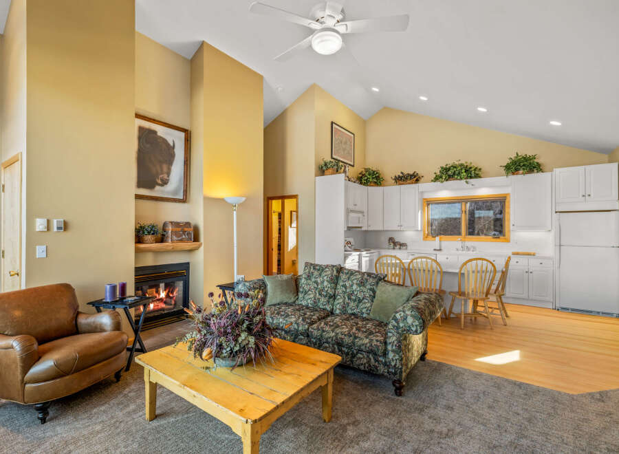 Step into this inviting living space, featuring a cozy fireplace and a comfortable seating area.