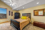 This inviting bedroom features a comfortable bed with a decorative quilt and vibrant yellow pillows, creating a cozy atmosphere.