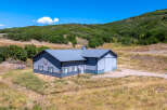 This stunning property boasts a spacious, modern barn-style building with ample room for various uses.