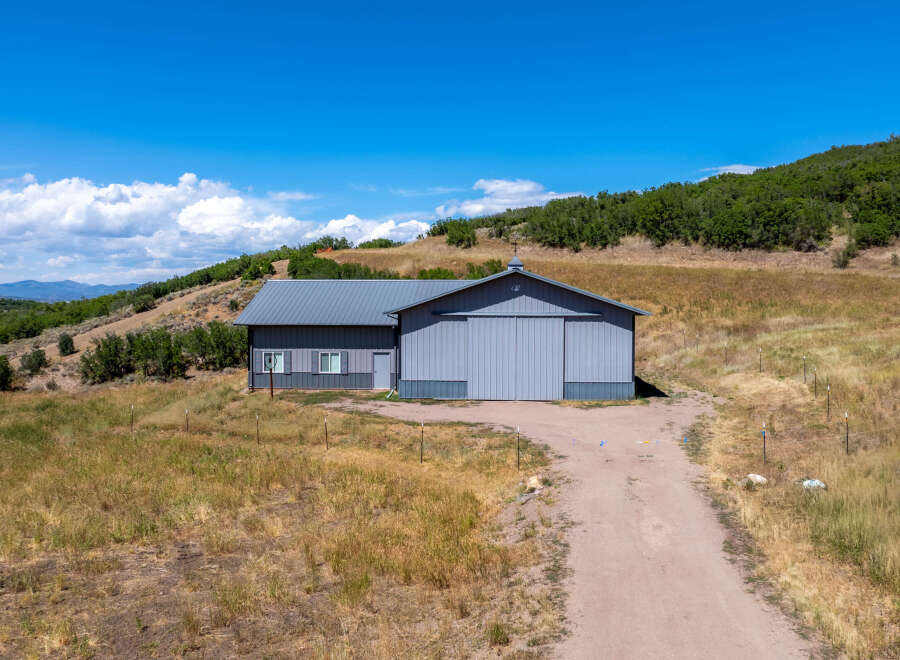 This stunning property features a spacious metal building with ample room for various uses.