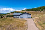 This stunning property features a spacious metal building with ample room for various uses.