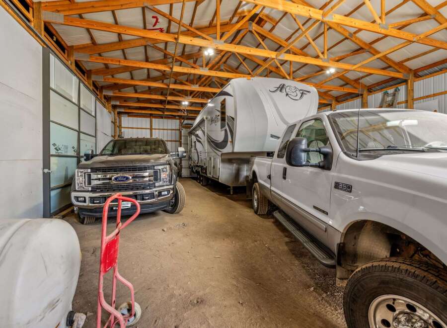 Spacious garage with high ceilings and ample room for vehicles and storage.