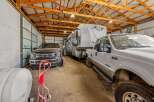 Spacious garage with high ceilings and ample room for vehicles and storage.