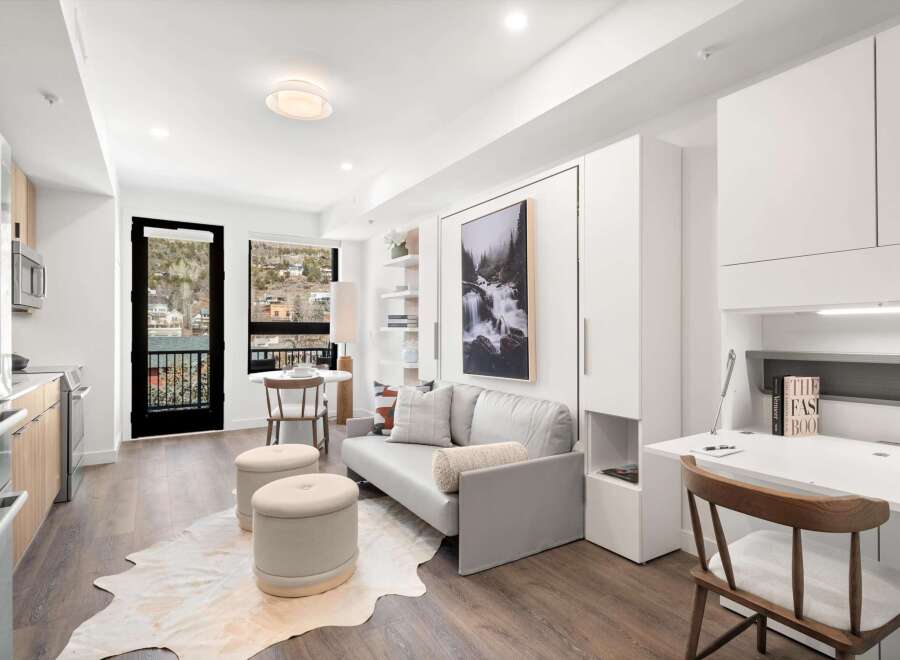 Experience modern living in this stylish apartment featuring a sleek kitchen, a comfortable living area, and a convenient desk space.
