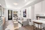 Experience modern living in this stylish apartment featuring a sleek kitchen, a comfortable living area, and a convenient desk space.
