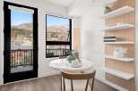 Enjoy breathtaking mountain views from this stunning property! This bright and airy space features a modern dining area with a sleek table and stylish decor.