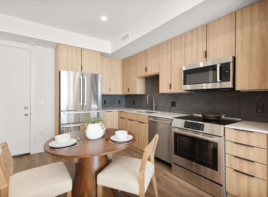 Step into modern elegance with this stunning kitchen! Featuring sleek stainless steel appliances, including a microwave and oven, and ample cabinet space, this kitchen is perfect for both cooking and entertaining.