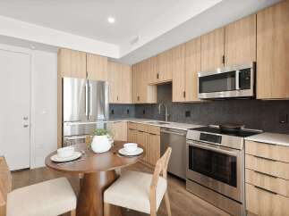 Step into modern elegance with this stunning kitchen! Featuring sleek stainless steel appliances, including a microwave and oven, and ample cabinet space, this kitchen is perfect for both cooking and entertaining.