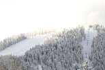 Experience the serenity of winter in this stunning mountain landscape.