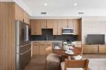 Experience modern living in this stunning kitchen, featuring sleek stainless steel appliances and custom wood cabinetry.