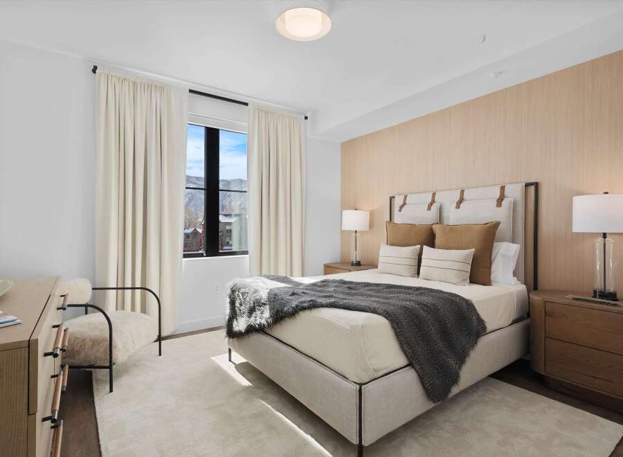Experience luxury in this stunning bedroom, featuring a plush bed and elegant decor.