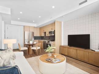 Experience modern living in this stylish apartment featuring a sleek kitchen with stainless steel appliances and ample cabinet space.