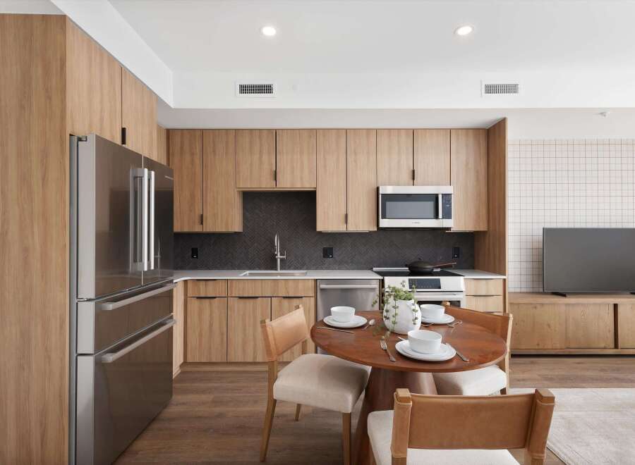Experience modern living in this stunning kitchen, featuring sleek stainless steel appliances and custom wood cabinetry.