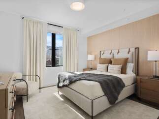 Experience luxury in this stunning bedroom, featuring a plush bed and elegant decor.