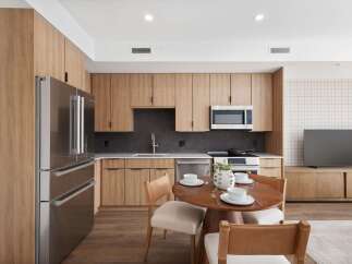 Experience modern living in this stunning kitchen, featuring sleek stainless steel appliances and custom wood cabinetry.
